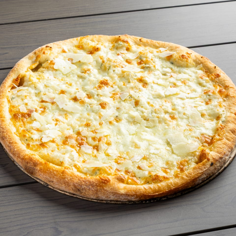 A Grande Pizza with a golden crust and a generous topping of white cheese and parmesan flakes.